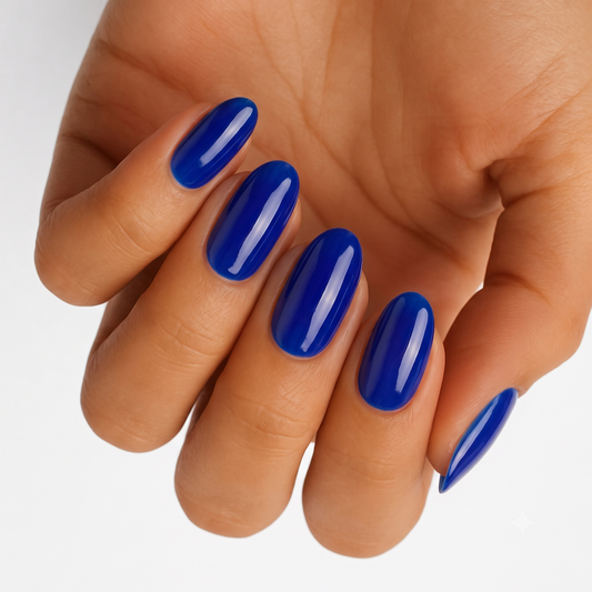 Cobalt blue glossy nail wraps with a jelly-like translucent finish on oval nails