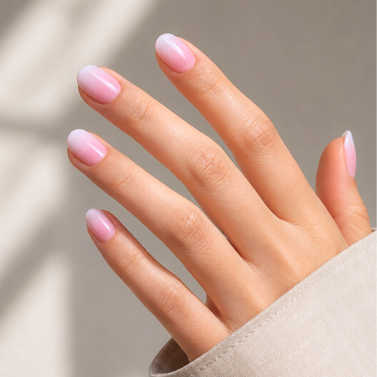 Soft gel press-ons with glazed pink-to-white ombré finish, extra short round shape.
