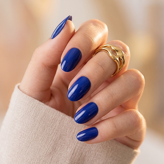Glossy navy blue soft gel press-on nails in a short oval shape