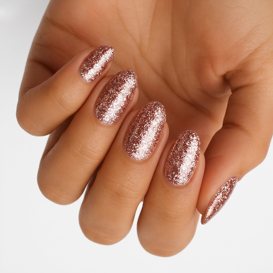 Rose gold copper glitter nail wraps with full glitter coverage on almond-shaped nails.