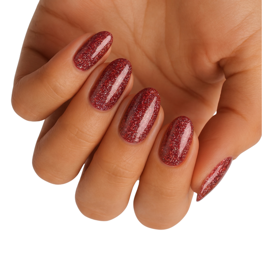 Deep red glittery nail wraps with holographic sparkle on an oval shape