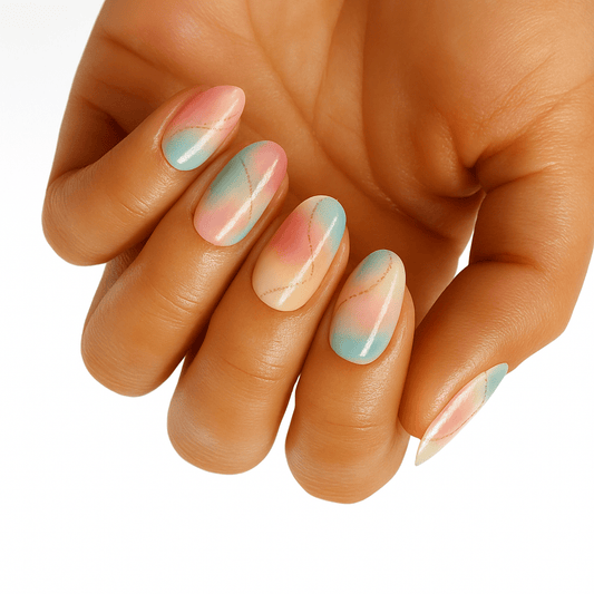 Hand displaying pastel pink and mint green marble nail wraps with soft watercolour finish