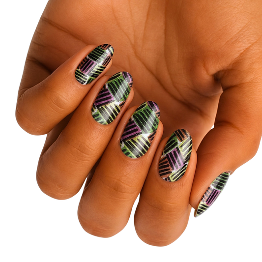 Nail wraps with black crosshatch pattern over green and purple glitter shimmer, wide fit