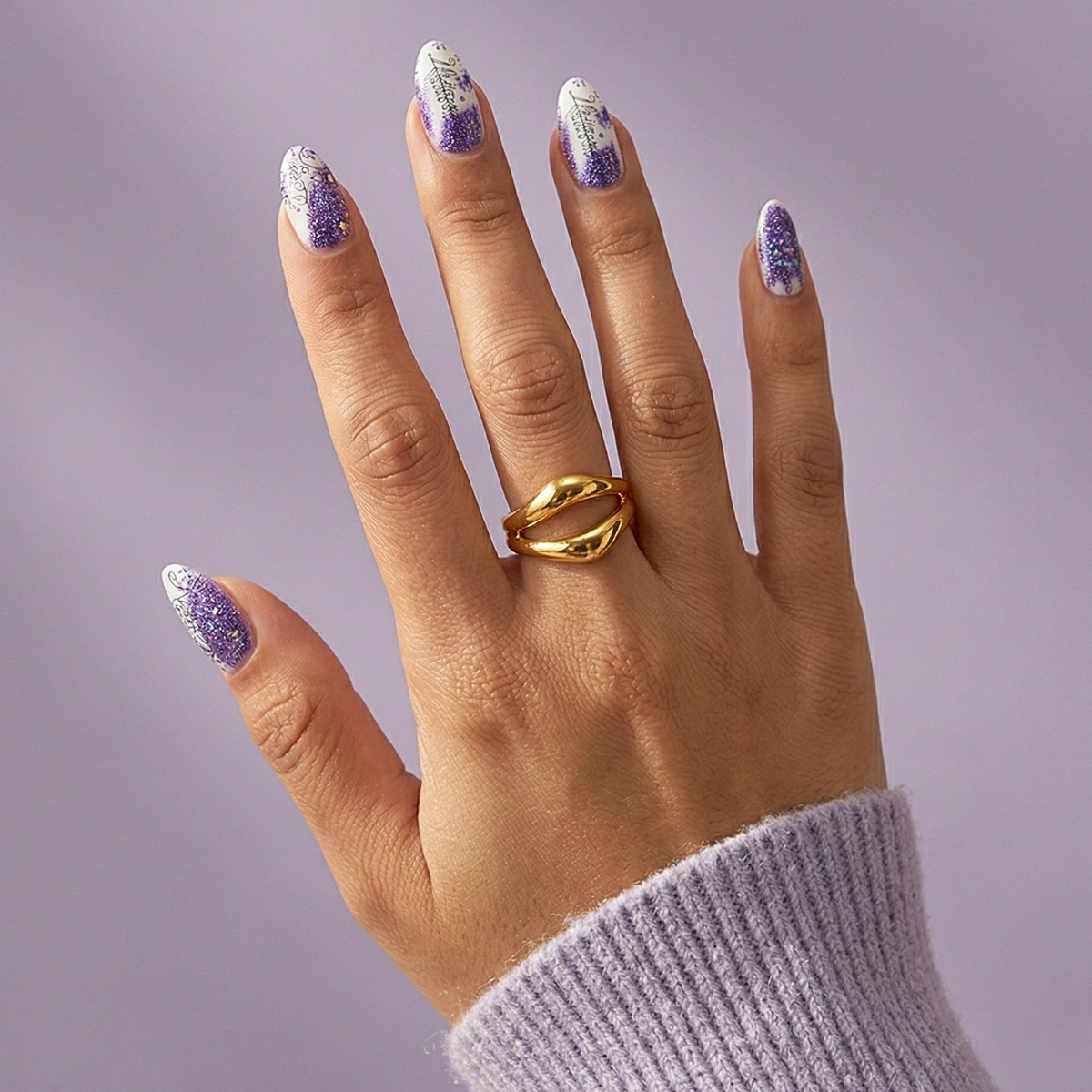 Almond nail wraps with purple glitter ombre, white script text and floral accents