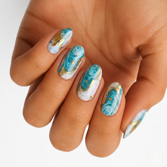 Teal and white marble nail wraps with gold foil accents, glossy almond-shaped finish.