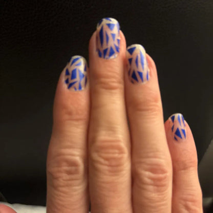Nail wraps with blue geometric shards on a sheer transparent background