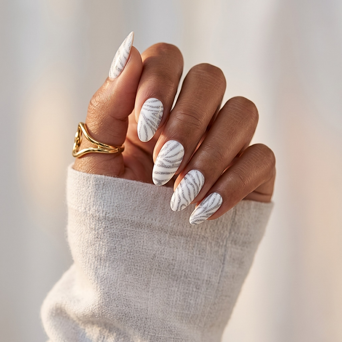 White nail wraps with silver glitter swirl stripes, matte finish on almond-shaped nails
