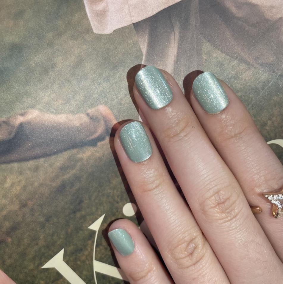 Sage green soft gel press-on nails with cat's eye shimmer, extra short natural shape