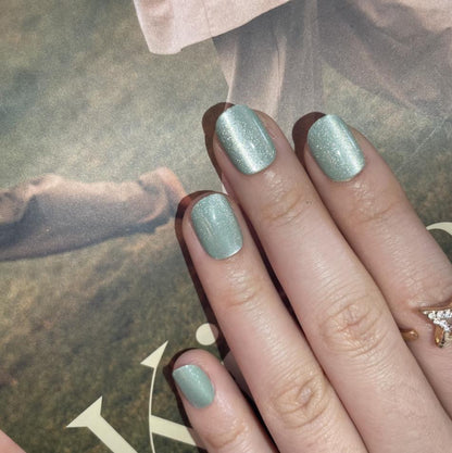 Sage green soft gel press-on nails with cat's eye shimmer, extra short natural shape