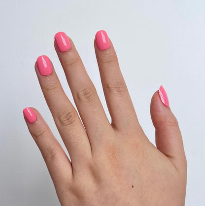 Bubblegum pink glossy soft gel press-on nails, extra short natural shape.