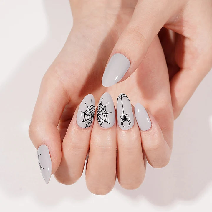Grey glossy semi-cured gel nail wraps with black spiderweb and spider Halloween design