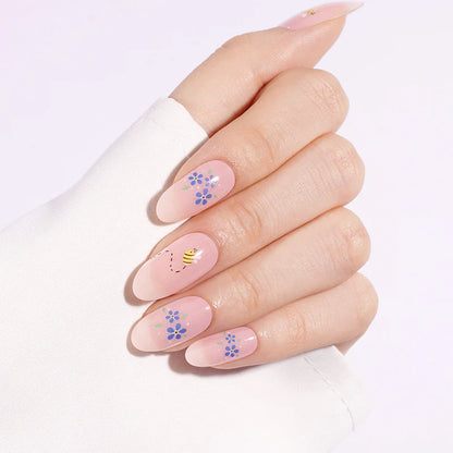 Sheer pink semi-cured gel nail wraps with blue floral and bee design