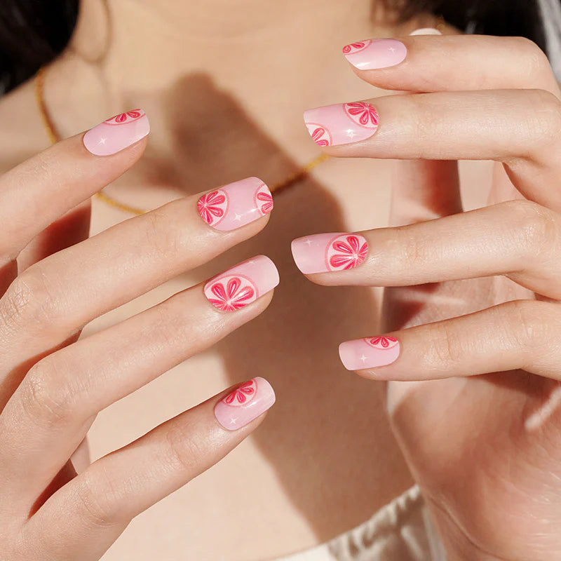 Semi-cured gel nail wraps in pink with red grapefruit citrus slice design, glossy finish