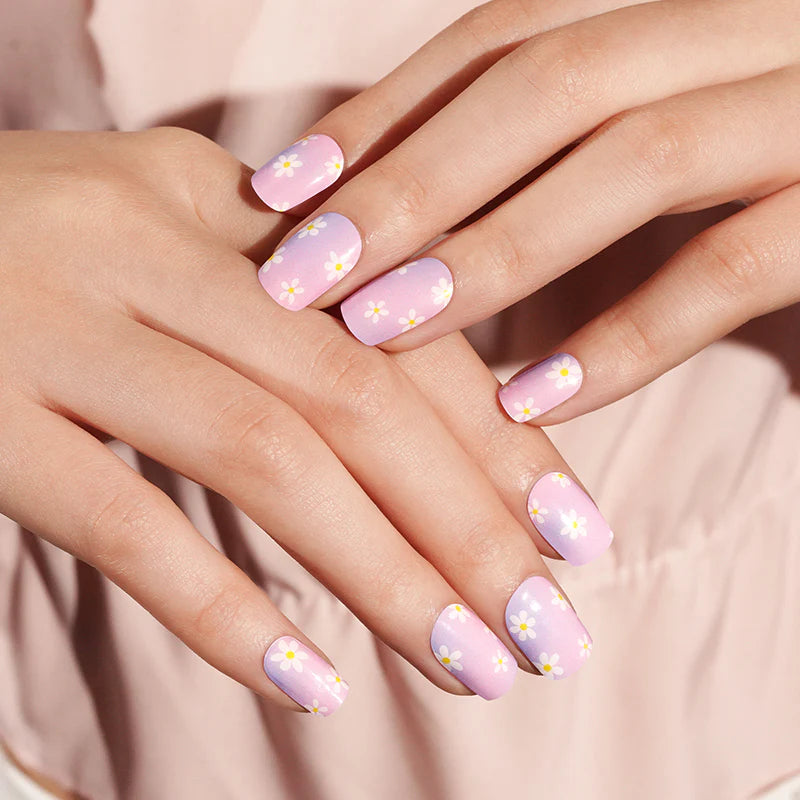 Semi-cured gel nail wraps in pink-to-lilac ombre with white daisy floral print
