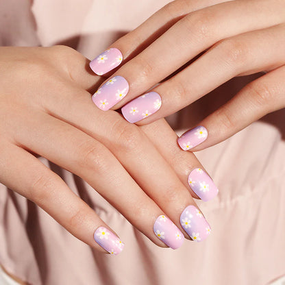 Semi-cured gel nail wraps in pink-to-lilac ombre with white daisy floral print