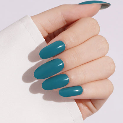Teal green glossy semi-cured gel nail wraps on oval-shaped nails