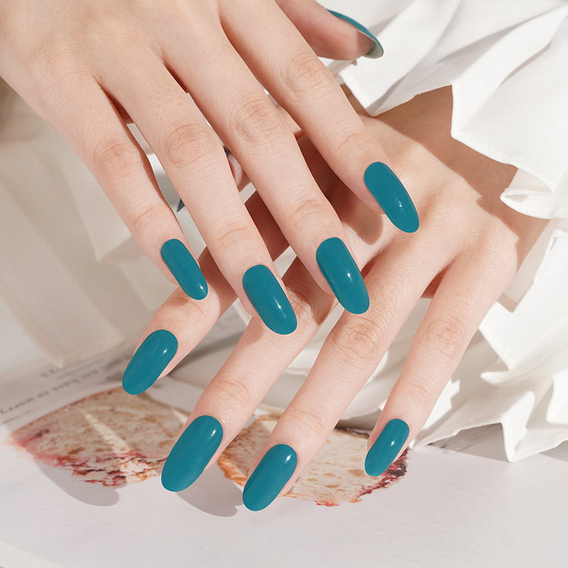 Teal green glossy semi-cured gel nail wraps on medium coffin-shaped nails
