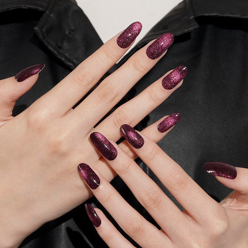 Deep burgundy semi-cured gel wraps with magnetic cat's-eye glitter, glossy almond-shaped nails