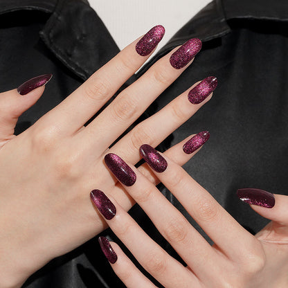 Deep burgundy semi-cured gel wraps with magnetic cat's-eye glitter, glossy almond-shaped nails