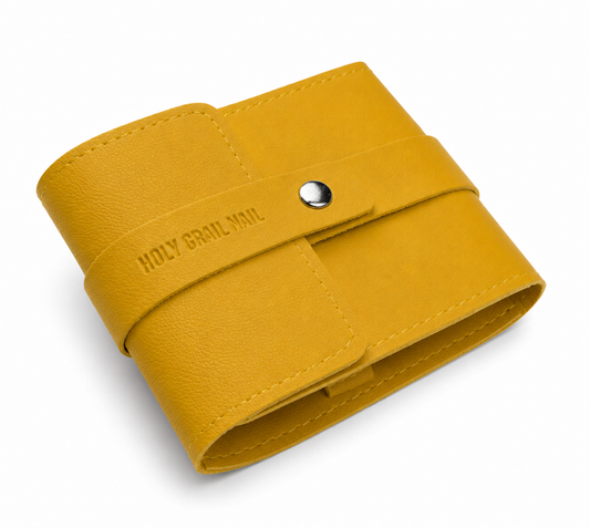 Mustard yellow faux leather travel case with snap closure, embossed Holy Grail Nail logo.