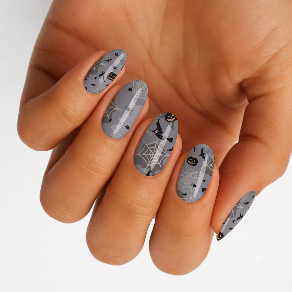 Grey nail wraps with Halloween spiderwebs, bats, pumpkins and witch hat design
