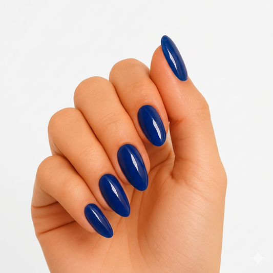 Navy blue glossy semi-cured gel nail wraps on almond-shaped nails, solid colour finish