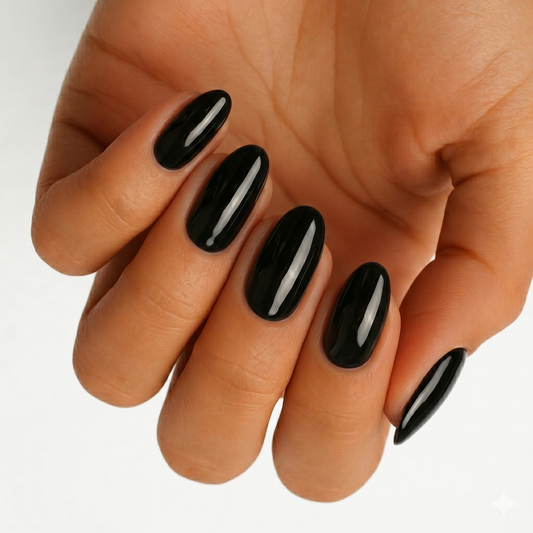 Glossy jet black nail wraps in a solid, high-shine finish on almond-shaped nails
