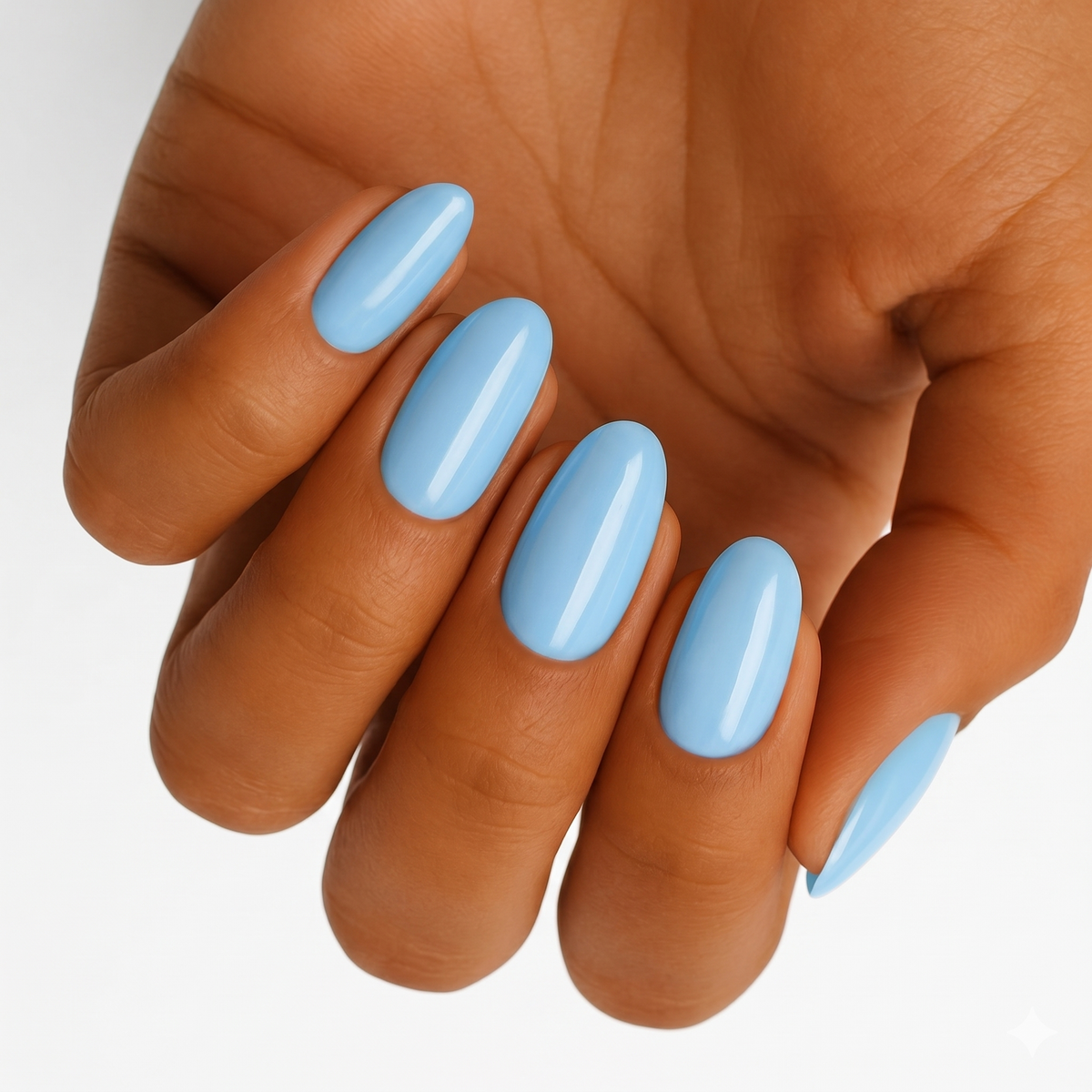 Sky blue glossy nail wraps in a solid colour on an oval almond shape