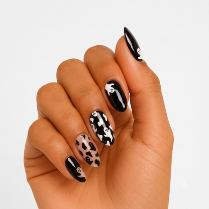 Black glossy semi-cured gel nail wraps with white ghost print and cow-spot accent nail