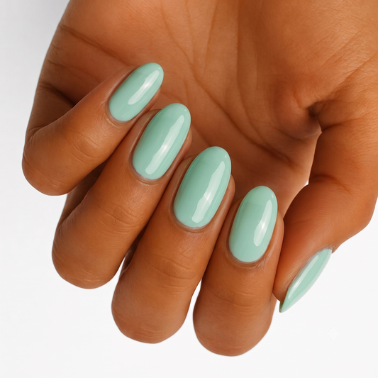 Sage green glossy nail wraps in a solid colour on almond-shaped nails