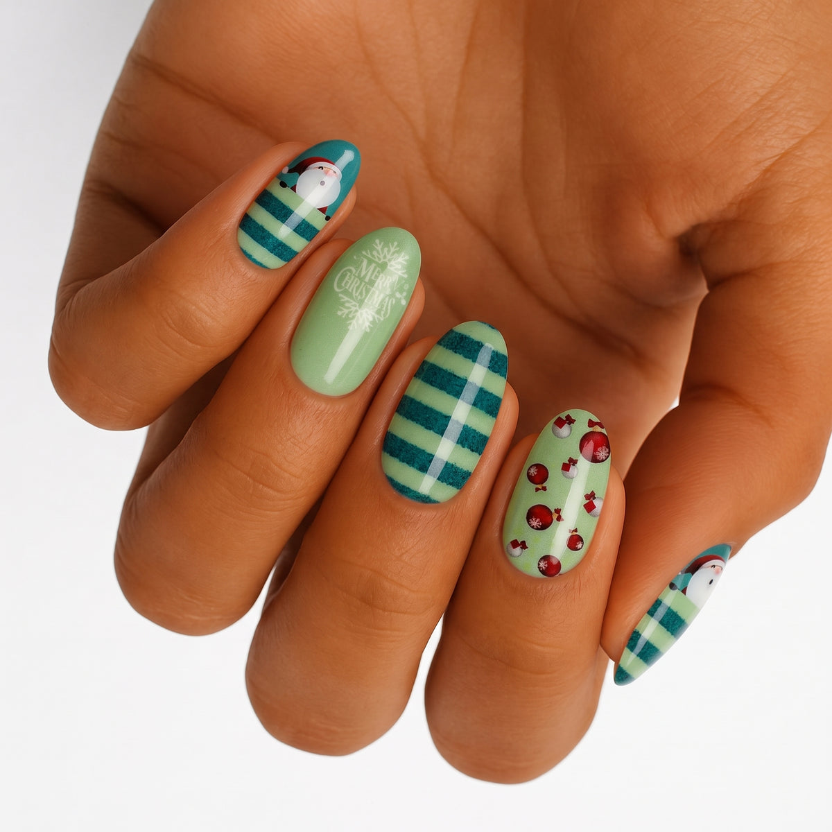 Green nail wraps with Santa, teal stripes, "Merry Christmas" text and ornaments
