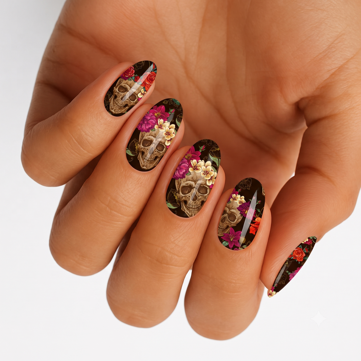 Black nail wraps with sugar skull and floral sugar skull art, red, pink, and gold florals
