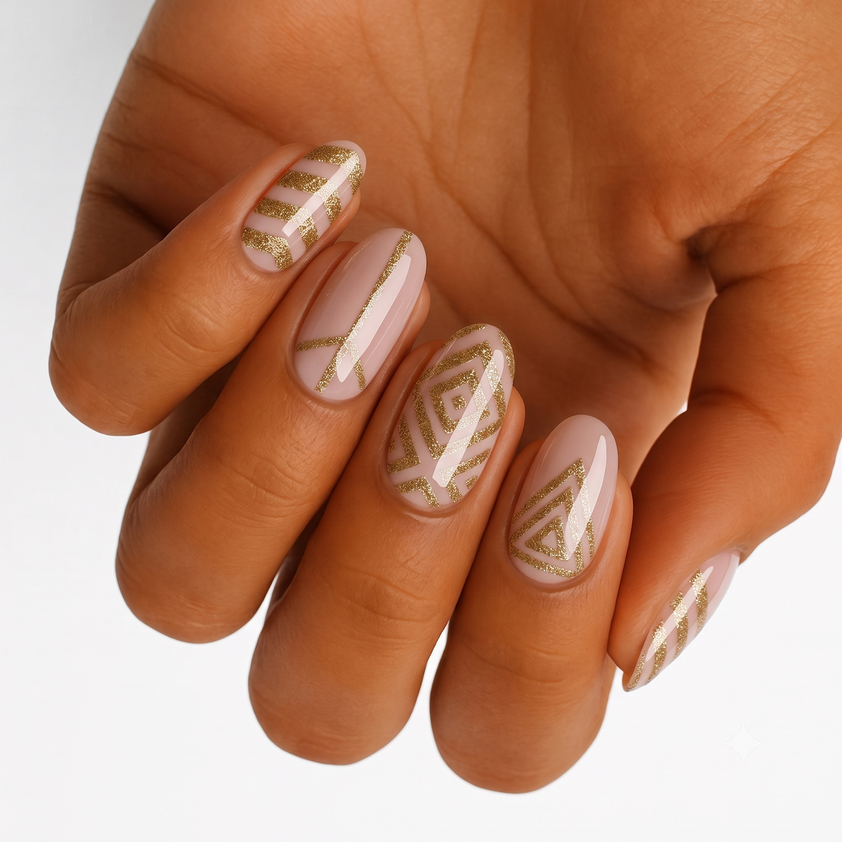 Nude nail wraps with glossy gold geometric line and triangle pattern