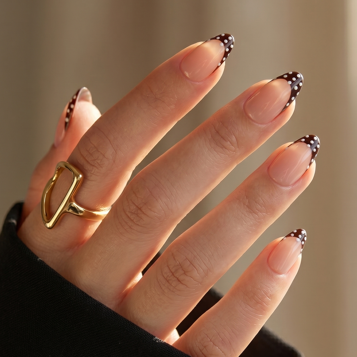 Glossy nude press-on nails with brown French tips and white polka dots