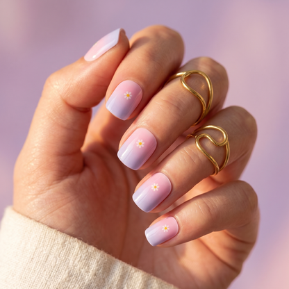 Glossy pink-to-lilac ombré semi-cured gel nail wraps with tiny white daisy accents.