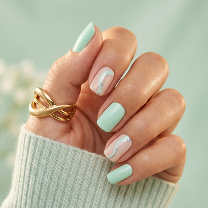 Mint green semi-cured gel nail wraps with nude swirl accent nails and silver glitter line