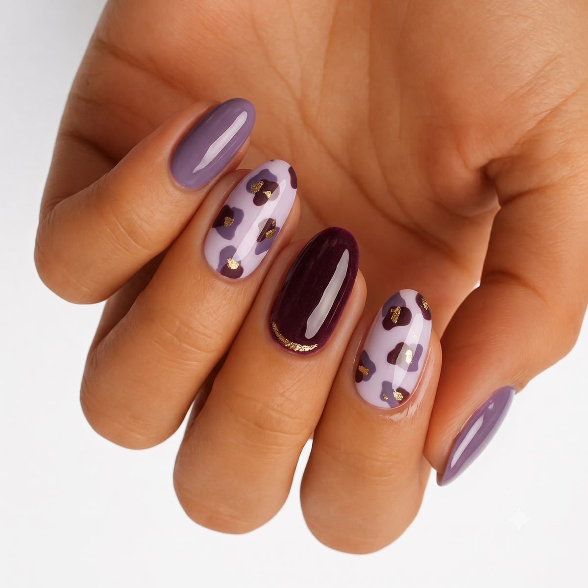 Purple glossy nail wraps with lilac leopard print and gold foil accents, deep plum accent nail.