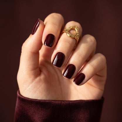 Deep burgundy-brown glossy nail wraps in a classic squoval shape
