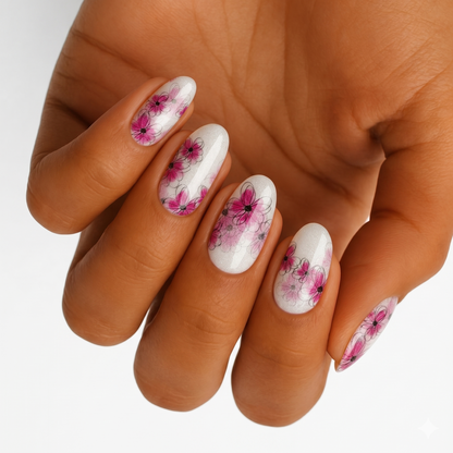 Shimmery white nail wraps with sheer pink floral line-art design on almond-shaped nails