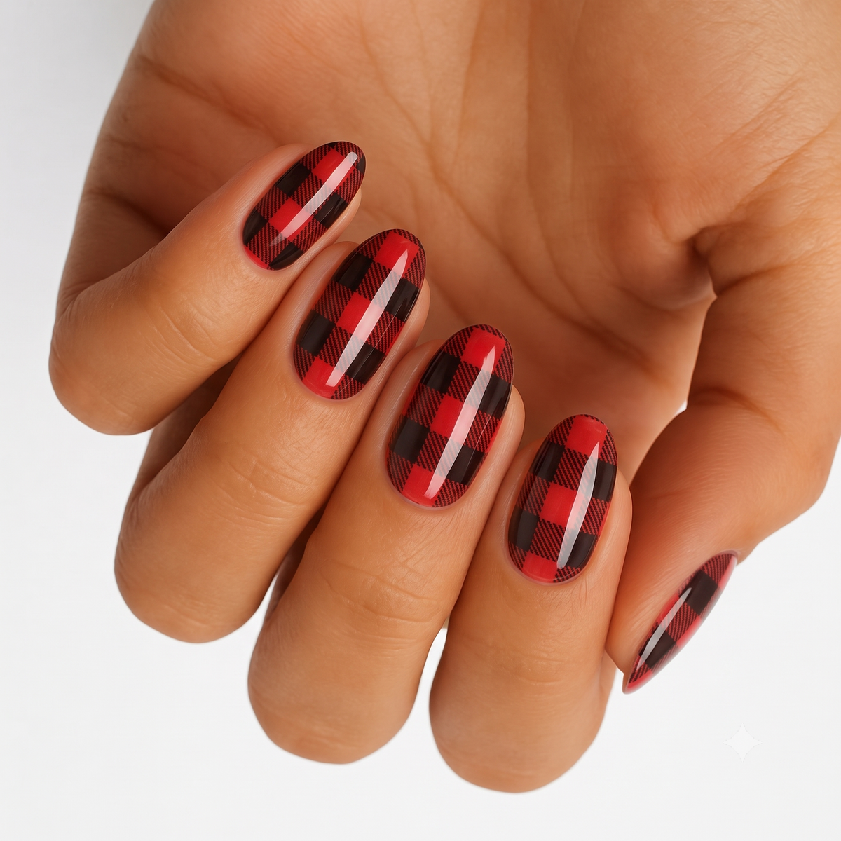 Glossy red and black buffalo plaid nail wraps on almond-shaped nails