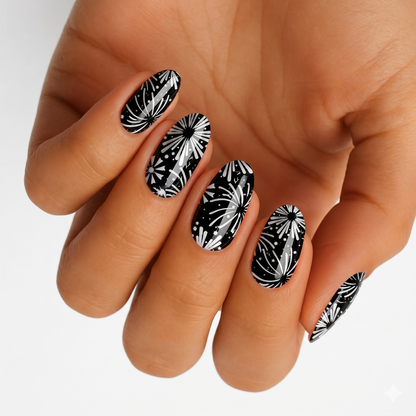 Black nail wraps with white firework burst design, glossy finish, almond shape