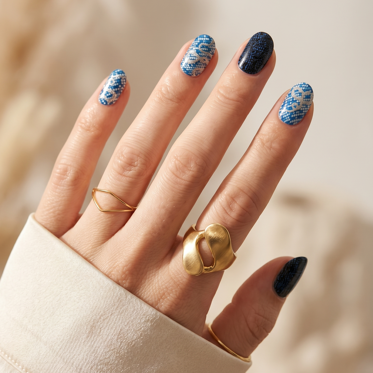 Semi-cured gel nail wraps in blue snake-print pattern with solid black accent nails
