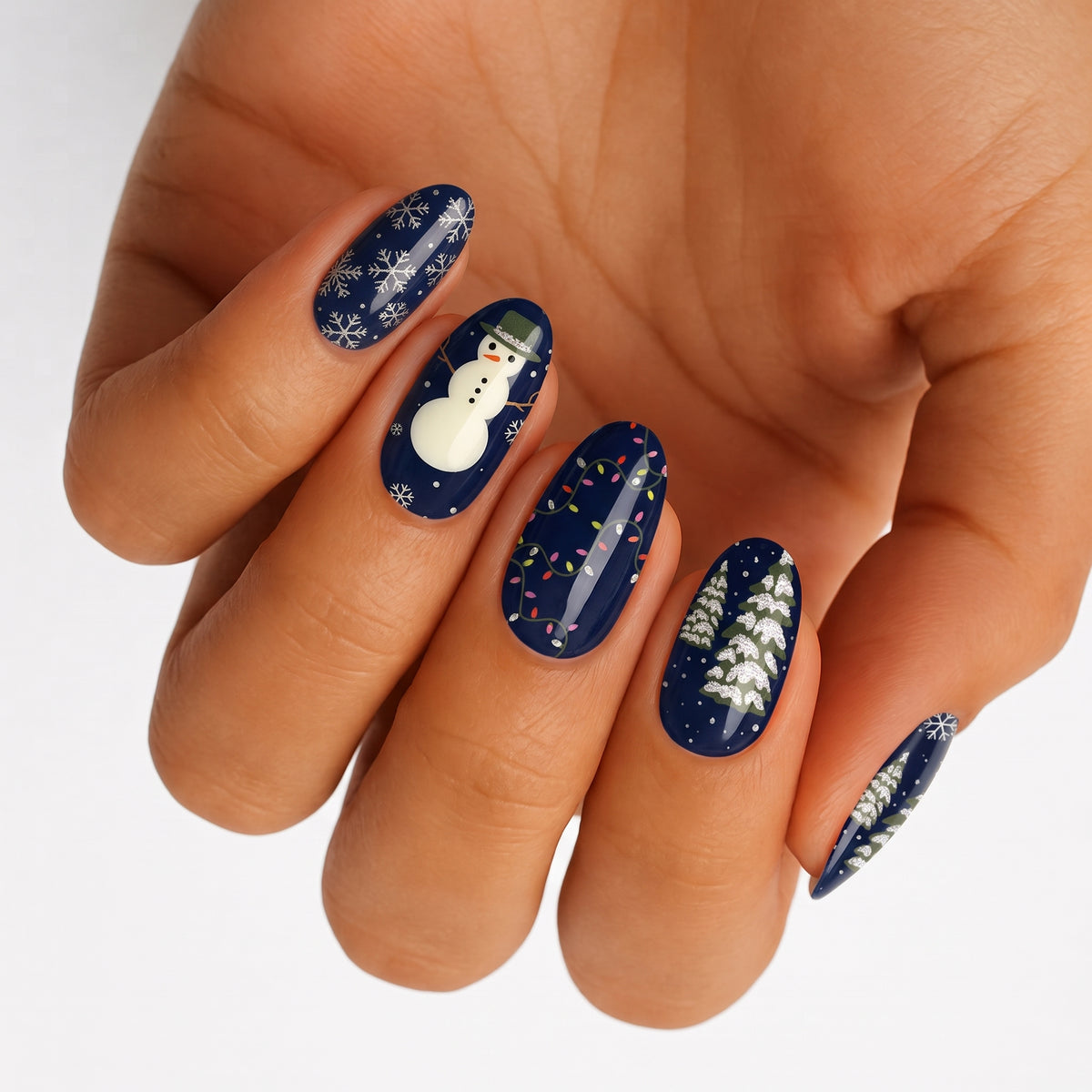 Navy blue nail wraps with snowman, snowflakes, fairy lights and snowy pine tree designs
