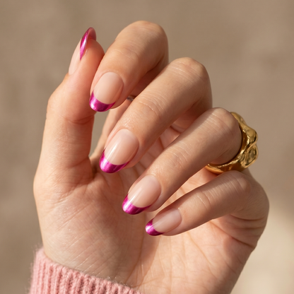 Short oval soft gel press-ons, sheer nude base with metallic magenta French tips