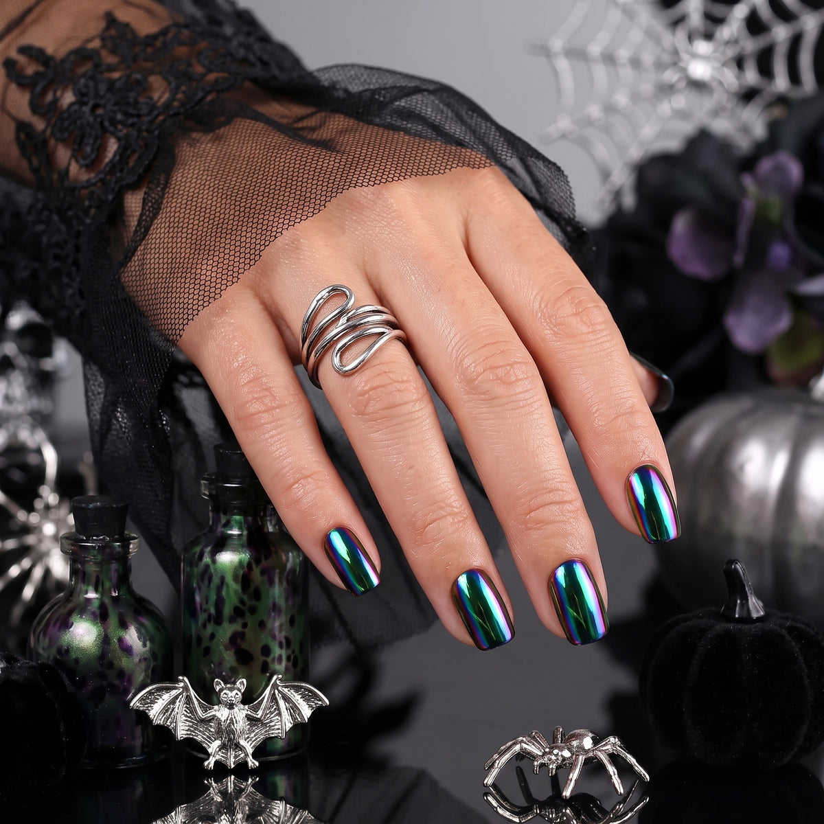 Short square soft gel press-ons in black with oil-slick chrome, blue-green-purple shift
