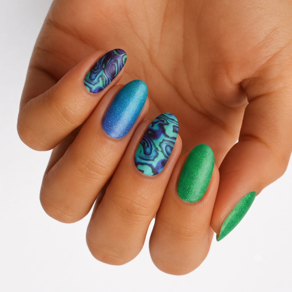 Holy Classics non-UV nail wraps with shimmery blue, green, and marbled abalone swirl designs