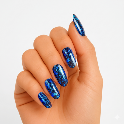 Deep blue semi-cured gel nail wraps with metallic foil-flake shard pattern, glossy finish, oval shape