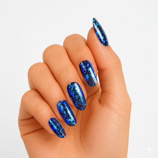 Deep blue semi-cured gel nail wraps with metallic foil-flake shard pattern, glossy finish, oval shape