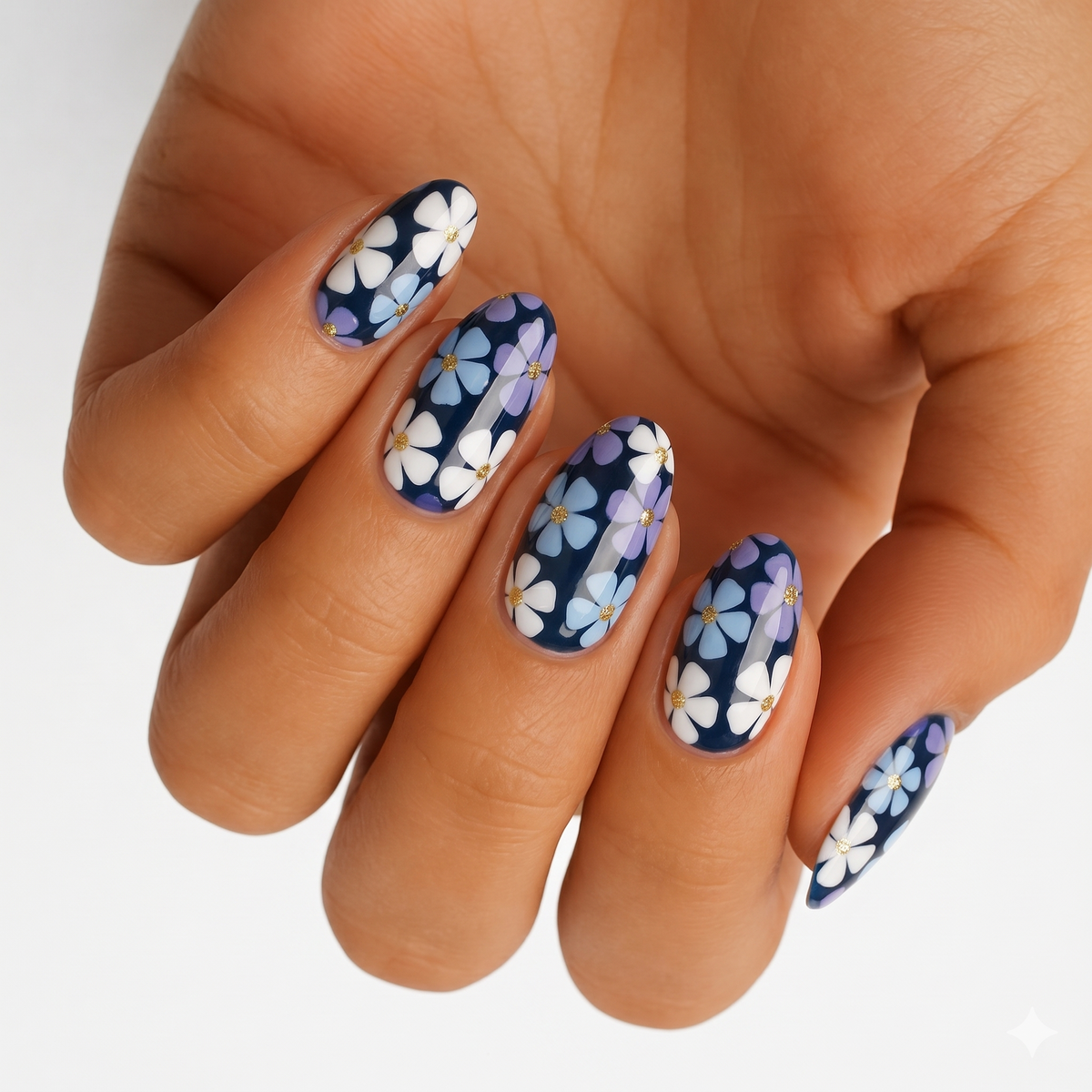 Navy nail wraps with white, lilac and blue daisy florals, glossy finish