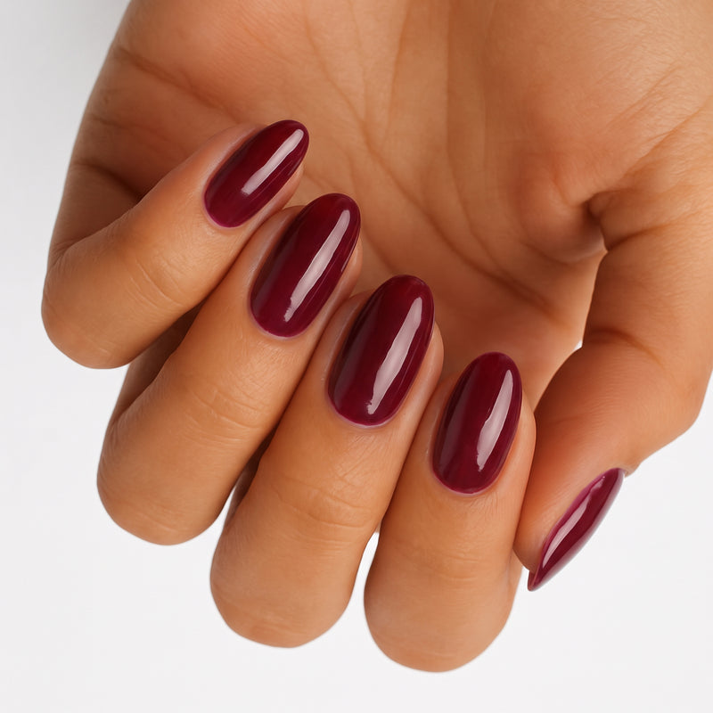 Deep burgundy glossy nail wraps on oval-shaped nails, Holy Classics non-UV design.